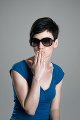 Young short hair beauty wearing sunglasses sending kiss at camera 