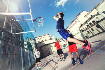 young basketball players playing with energy in a urban place