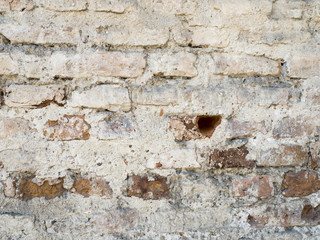 White red old brick painted wall with damaged plaster texture background