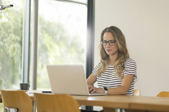 Woman at home working on laptop