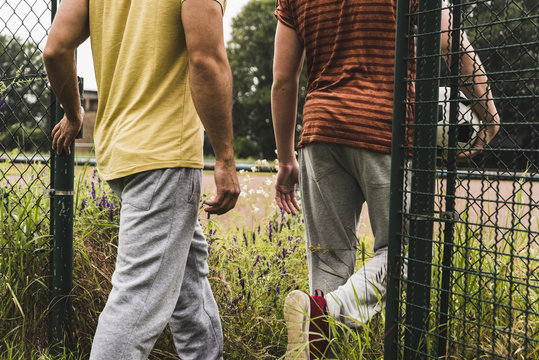 Close-up of two men entering football ground