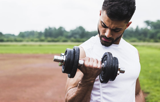 Athlete exercising with dumbbells