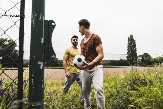 Two men at football ground