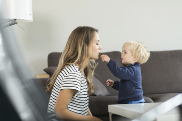 Mother and son at home with lipstick