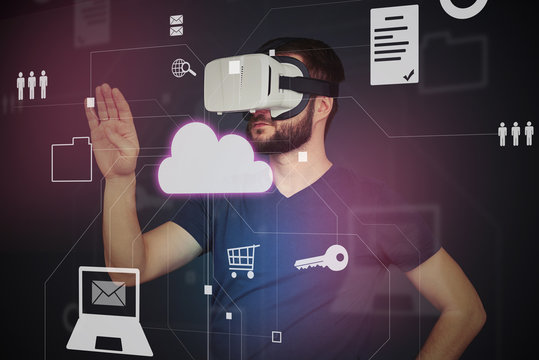  Young man in high tech VR-headset using interactive touch scree