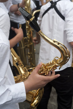 a boy helds a saxophone at a concert