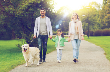 happy family with labrador retriever dog in park