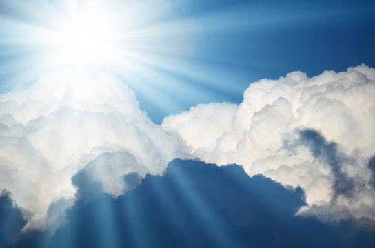Bright sun shines among the white clouds