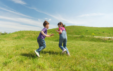 group of happy kids running outdoors