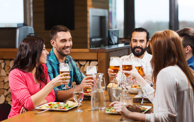 friends dining and drinking beer at restaurant