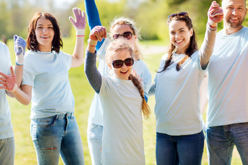 Fototapeta premium group of volunteers celebrating success in park
