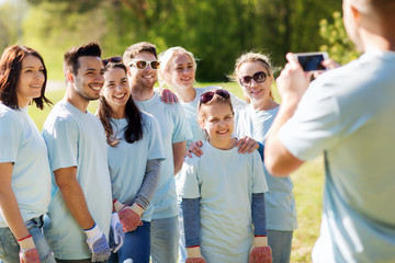 group of volunteers taking picture by smartphone