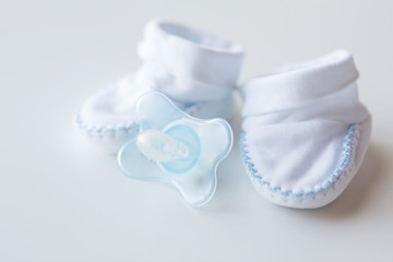 close up of baby bootees and soother for newborn