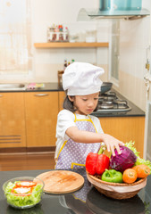 Little asian girl preparing vegetable to making salad in kitchen,Cooking  concept of happy asian little girl and mother making salad