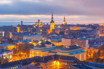 Aerial cityscape with Medieval Old Town illuminated at sunset with Saint Nicholas Church, Cathedral Church of Saint Mary and Alexander Nevsky Cathedral in Tallinn, Estonia