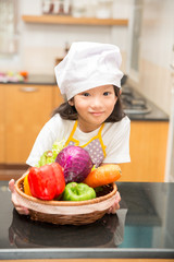 Little asian girl preparing vegetable to making salad
