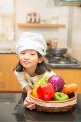 Little asian girl preparing vegetable to making salad
