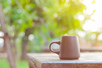 ceramic coffee cup with blur garden background