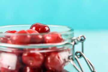 Jar Of Red Fresh Cherries On Turquoise Background