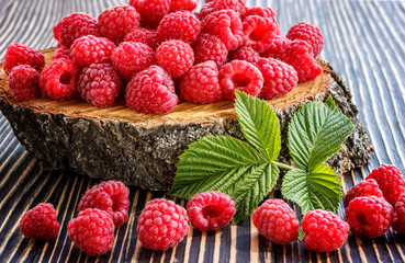 fresh raspberry on a wooden table outdoors