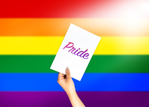 Pride on card with hand holding; LGBT color flag