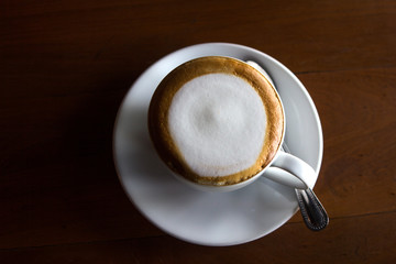 Cup of latte art coffee with froth milk