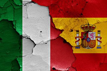 flags of Italy and Spain painted on cracked wall