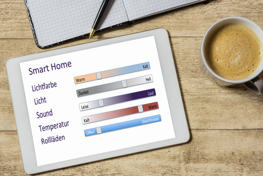 Tablet mit Smart Home Applikation auf einem Holztisch