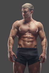 Muscular shirtless athlete in black panties.