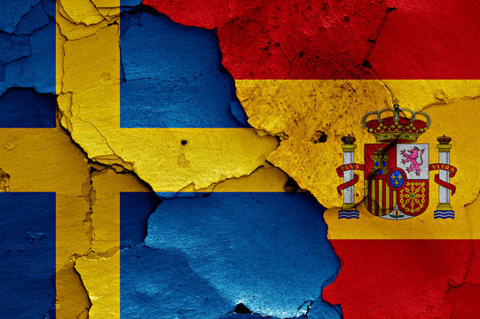 flags of Sweden and Spain painted on cracked wall