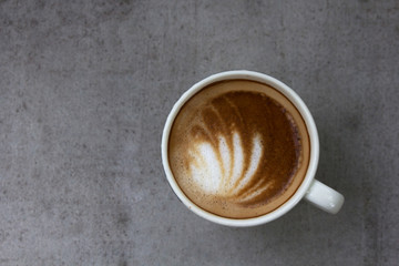 Cup of latte art coffee with froth butterfly