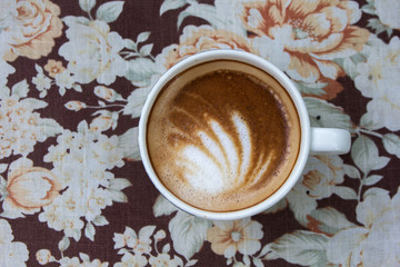 Cup of latte art coffee with froth butterfly