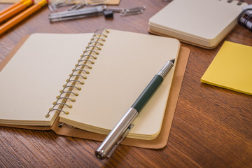 Notebook and school supplies on a wood table