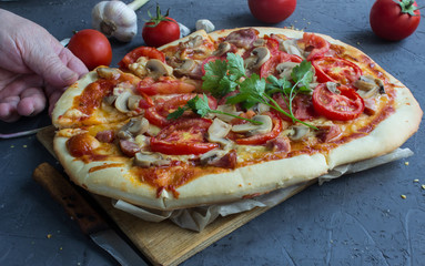 homemade pizza with sausage and tomatoes.