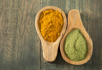 Moringa and turmeric on wooden background
