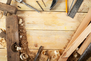 carpenter tools on wood table background