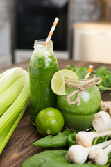 Fresh fruits and bottle with smoothies on kitchen table