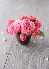 beautiful pink rose on wooden table