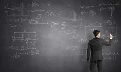 Man writing on blackboard