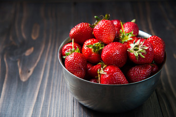 Fresh strawberries on old wooden background