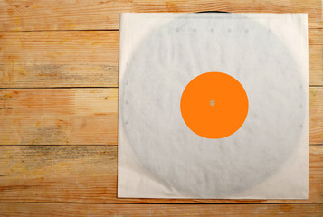 Retro styled image of a collection of old vinyl record lp's with sleeves on a wooden background....