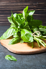 bunch of fresh organic basil on cutting board