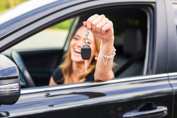 Young Happy Woman Showing The Key Of New Car