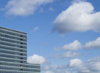 Construction site. Modern high-rise building. Blue sky background.