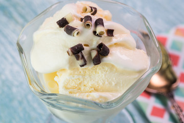 Vanilla ice cream with chocolate curls topping.