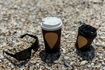 coffee cups and glasses on the seashore