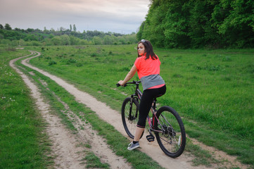 Fototapeta premium A girl riding a bike