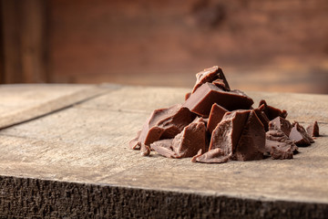 Pieces of milk Chocolate on wood