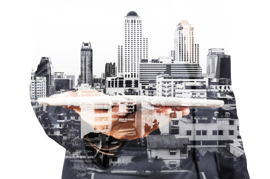 Double exposure of Businessman with Tablet and Modern City Build