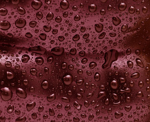 Water drops on red surface.